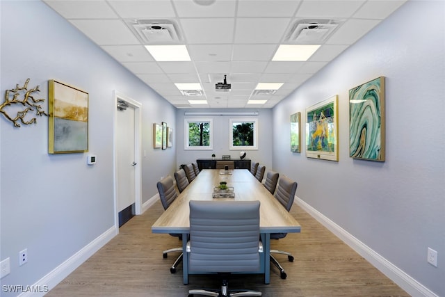 dining area featuring a drop ceiling, wood finished floors, visible vents, and baseboards