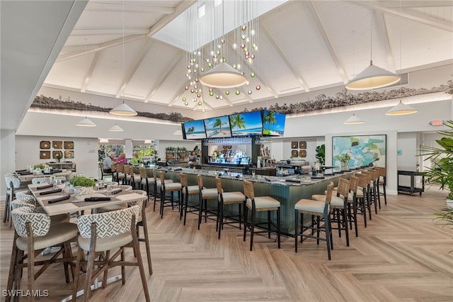 bar featuring high vaulted ceiling, beam ceiling, and pendant lighting