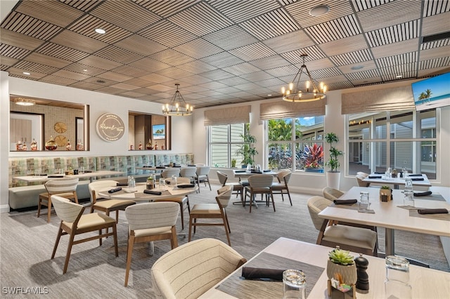 dining room with baseboards and a notable chandelier