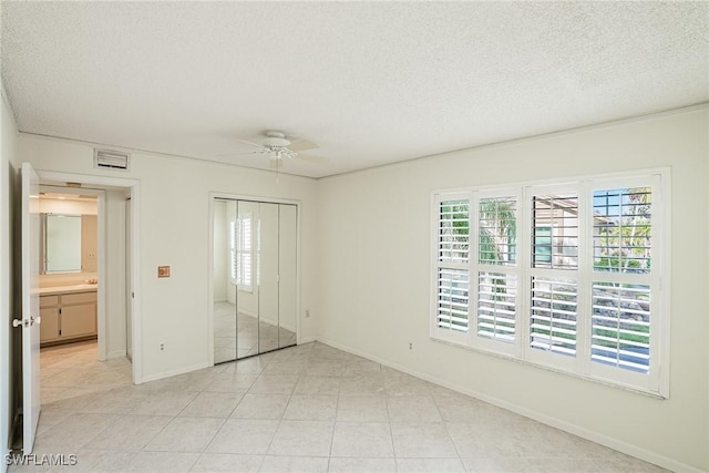 unfurnished room with light tile patterned floors, a textured ceiling, ceiling fan, and ornamental molding