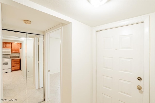 corridor featuring light tile patterned flooring