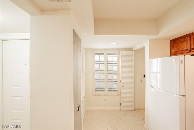 kitchen featuring white fridge and light tile patterned floors