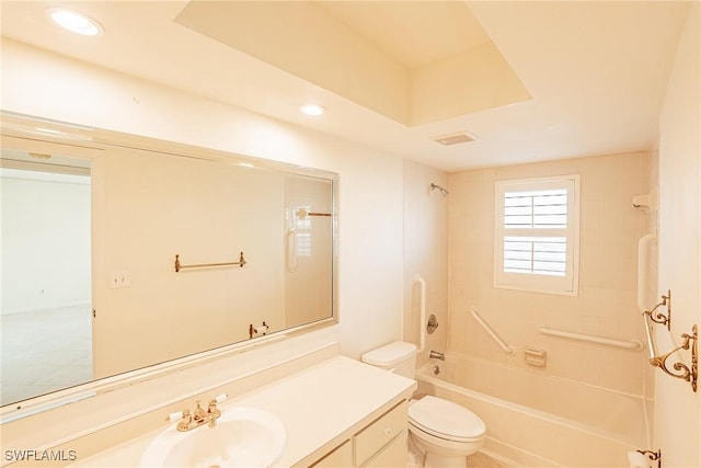 full bathroom featuring tiled shower / bath combo, toilet, and vanity