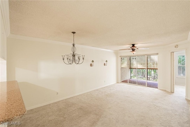 carpeted empty room featuring ceiling fan with notable chandelier, a textured ceiling, and ornamental molding