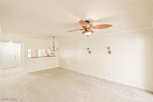 unfurnished room featuring crown molding, ceiling fan with notable chandelier, light colored carpet, and a textured ceiling