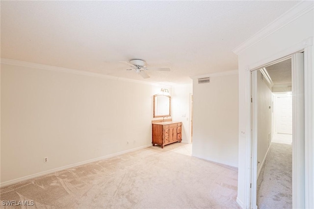 carpeted empty room with ceiling fan, a textured ceiling, and ornamental molding