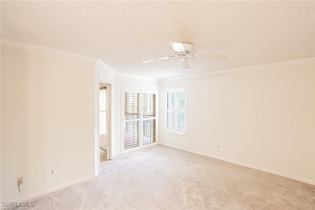 unfurnished room featuring light carpet, a textured ceiling, ceiling fan, and ornamental molding