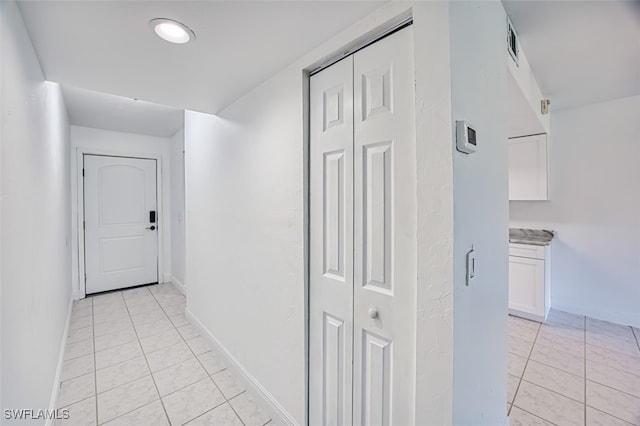 hallway featuring light tile patterned flooring