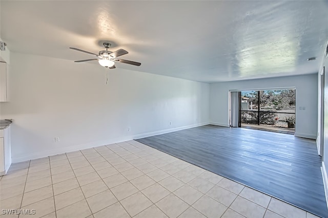 unfurnished living room with light tile patterned floors and ceiling fan