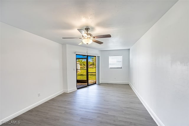 spare room with hardwood / wood-style floors and ceiling fan