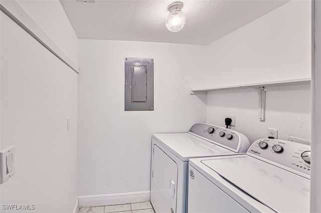 laundry room with electric panel, light tile patterned floors, and independent washer and dryer