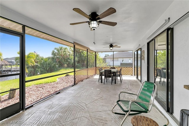 sunroom featuring ceiling fan