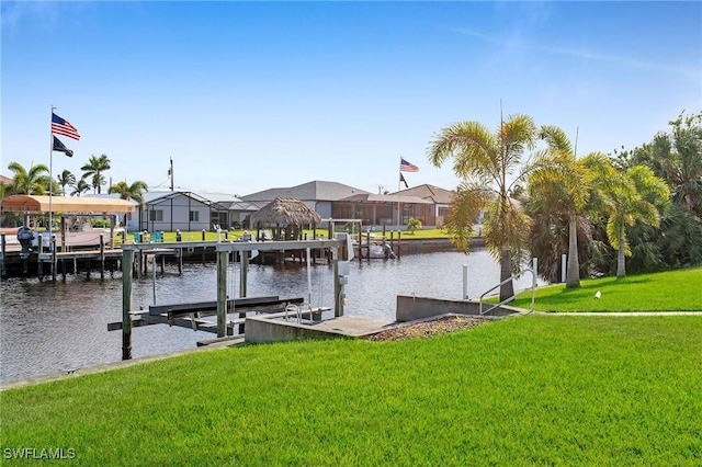 view of dock featuring a water view and a yard