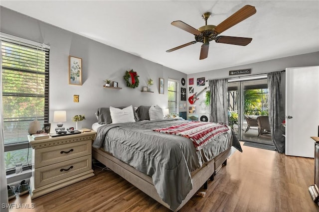 bedroom featuring access to exterior, wood-type flooring, multiple windows, and ceiling fan