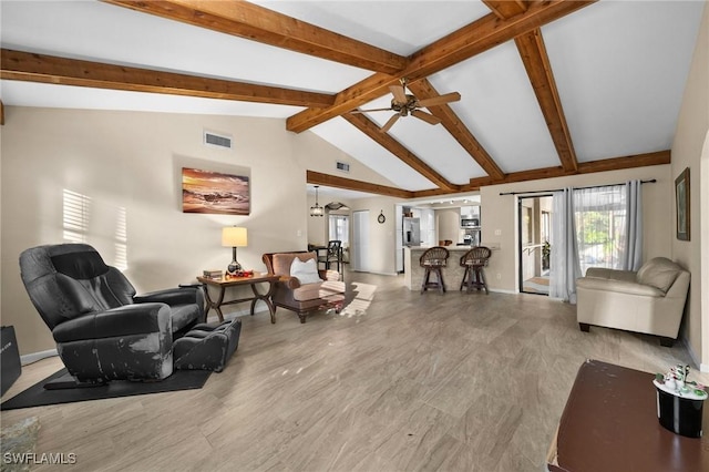 living room featuring vaulted ceiling with beams and ceiling fan