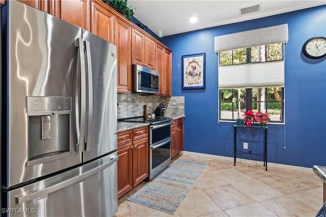 kitchen with backsplash, stainless steel appliances, and light stone counters