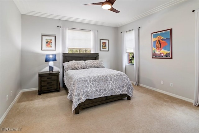 bedroom with ceiling fan, light colored carpet, and multiple windows