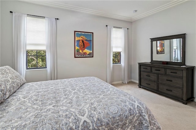 bedroom with multiple windows and light colored carpet