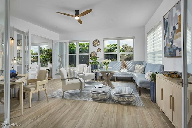 sunroom / solarium with plenty of natural light and ceiling fan