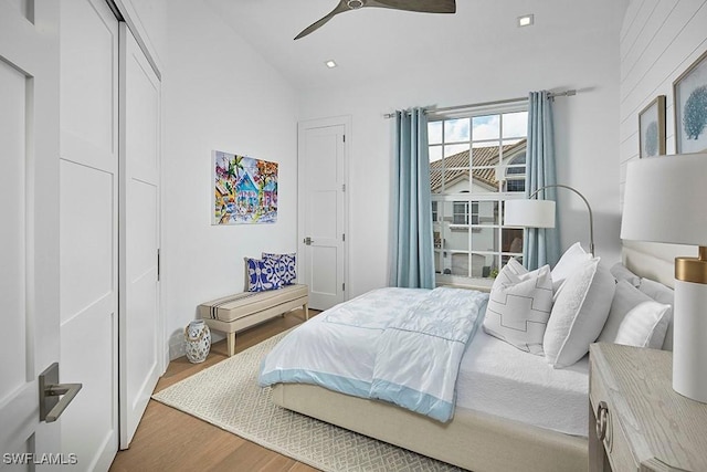 bedroom with vaulted ceiling, hardwood / wood-style floors, and ceiling fan