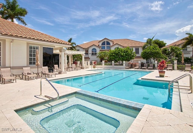 view of pool featuring a pergola, a patio area, and a hot tub