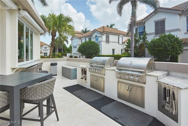231 Colonade Cir, Naples, FL 34103 - view of patio / terrace featuring an outdoor kitchen
