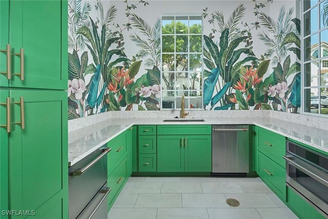 231 Colonade Cir, Naples, FL 34103 - kitchen with green cabinets, stainless steel appliances, light tile patterned floors, and plenty of natural light