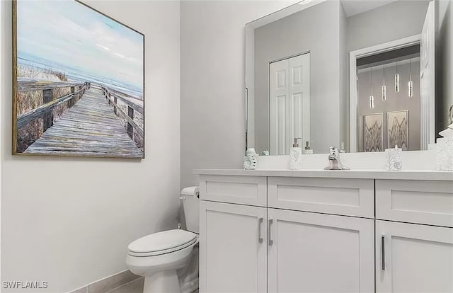 bathroom with tile patterned flooring, vanity, and toilet