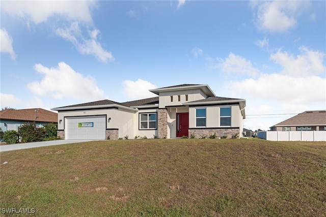 prairie-style house featuring a front lawn and a garage