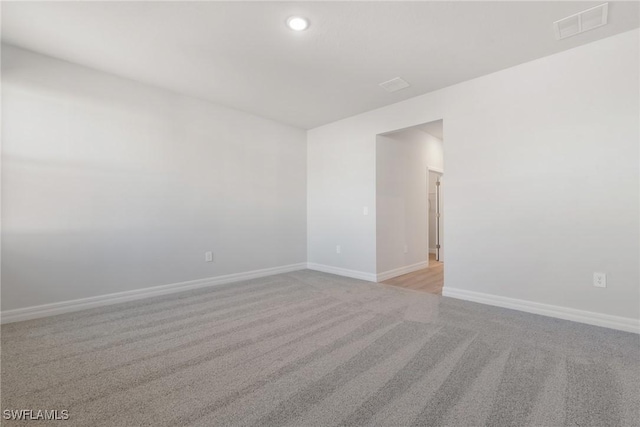 empty room with light colored carpet