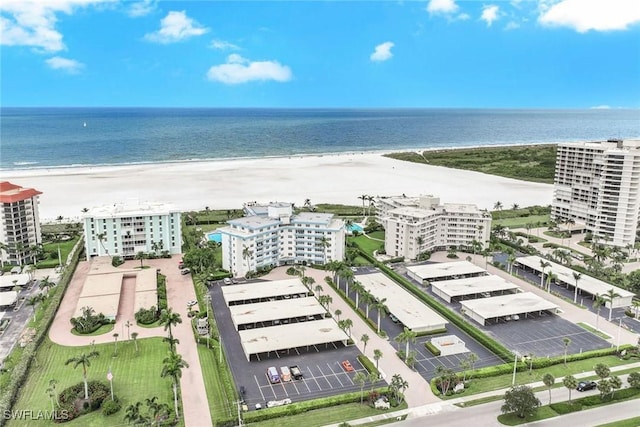 birds eye view of property featuring a view of the beach and a water view