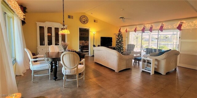 living room featuring dark tile patterned flooring and lofted ceiling