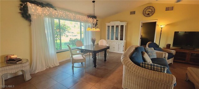 dining room with tile patterned floors, lofted ceiling, and a notable chandelier