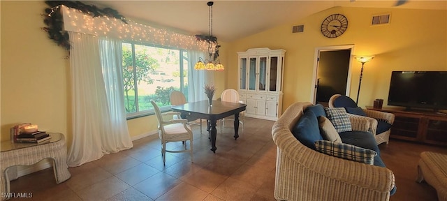 tiled dining area with vaulted ceiling