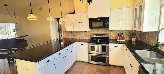 kitchen featuring white cabinetry, hanging light fixtures, sink, and range with two ovens