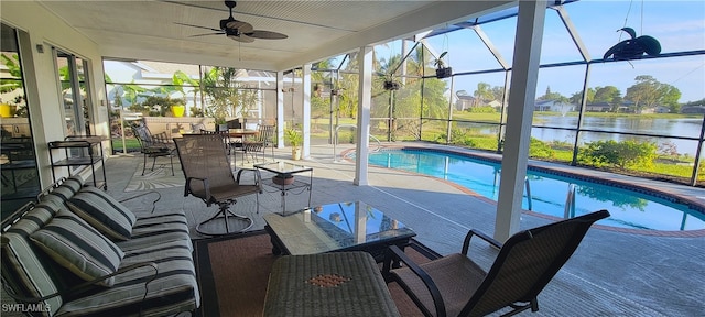 exterior space with a water view, ceiling fan, a patio, and glass enclosure