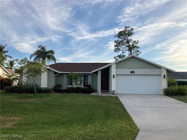 ranch-style house with a garage and a front lawn