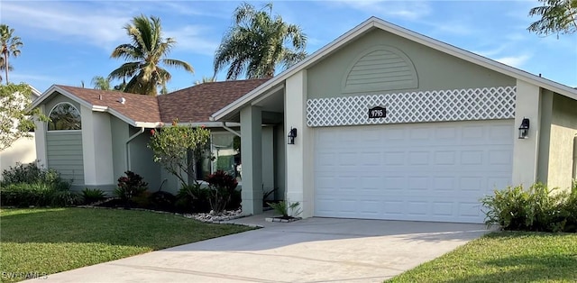 view of front of property with a garage and a front yard