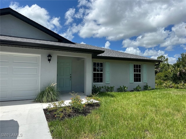 exterior space featuring a lawn and a garage