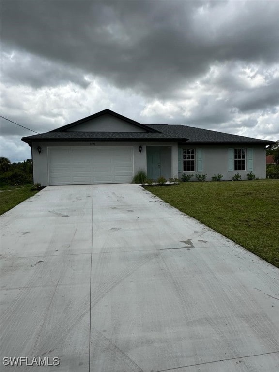 single story home with a front yard and a garage