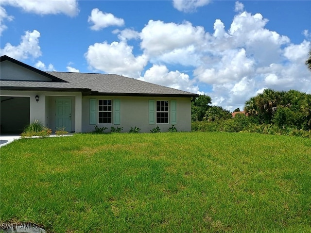 view of side of property with a garage and a yard