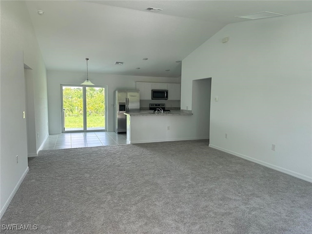 unfurnished living room with light colored carpet and high vaulted ceiling