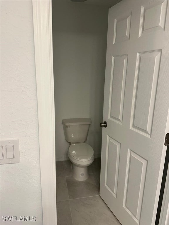 bathroom featuring tile patterned floors and toilet