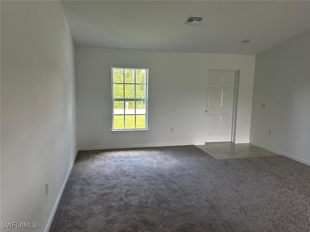 empty room with dark colored carpet