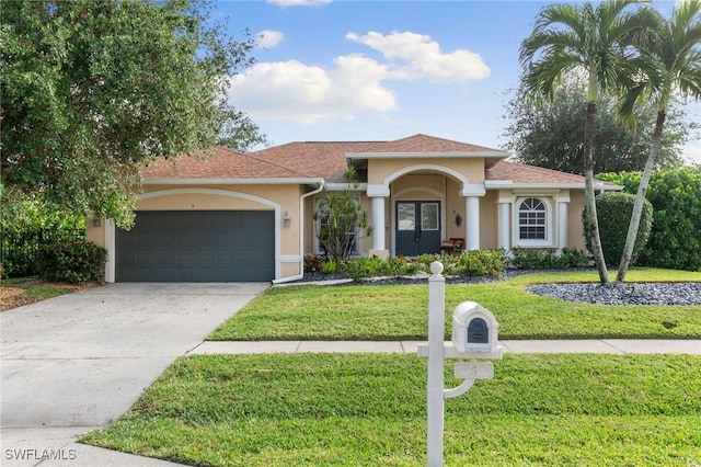 mediterranean / spanish-style house featuring a front lawn and a garage