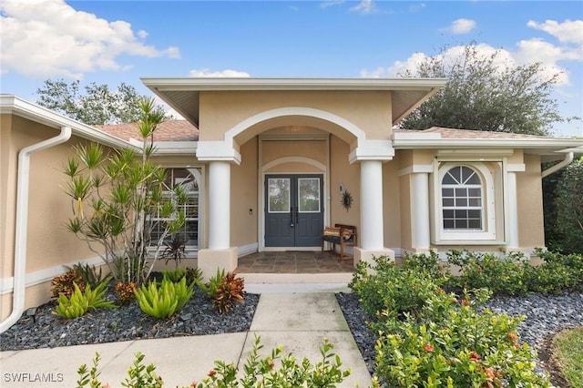 view of exterior entry featuring french doors