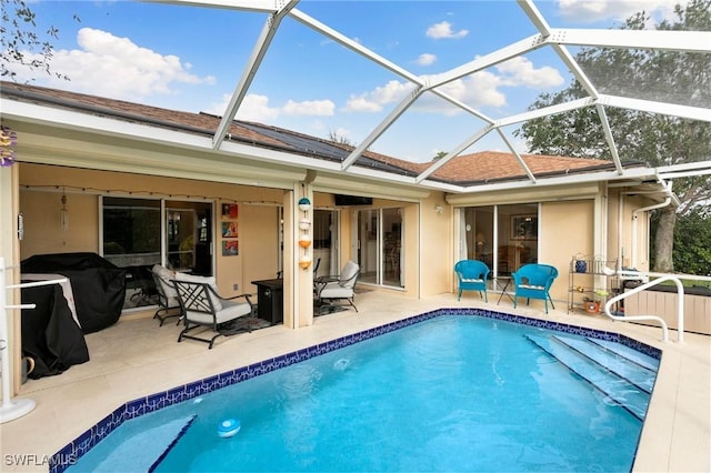 view of pool featuring a lanai, a patio area, and a grill