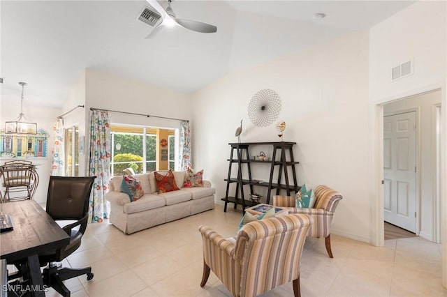 tiled living room featuring ceiling fan with notable chandelier and high vaulted ceiling