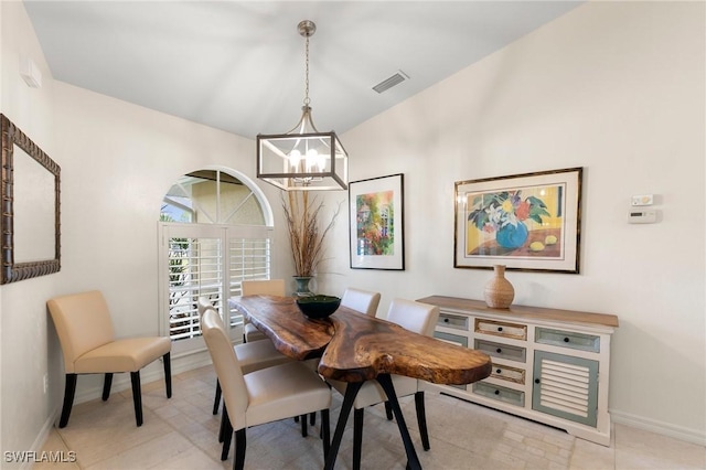 tiled dining room featuring a notable chandelier