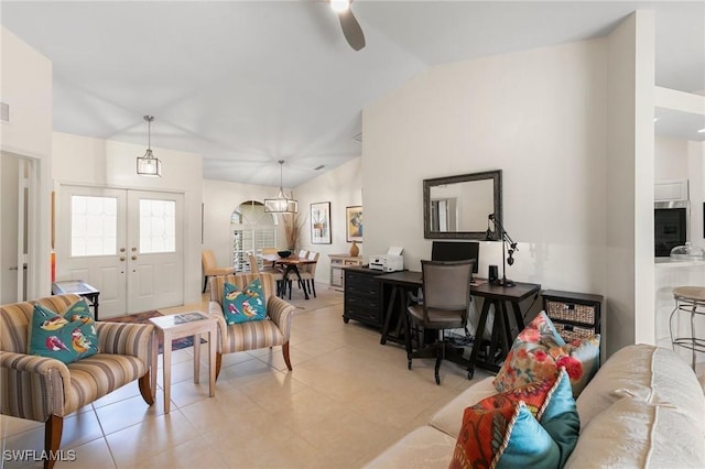 tiled living room with french doors, vaulted ceiling, and ceiling fan